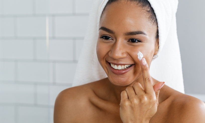 Woman applying face cream