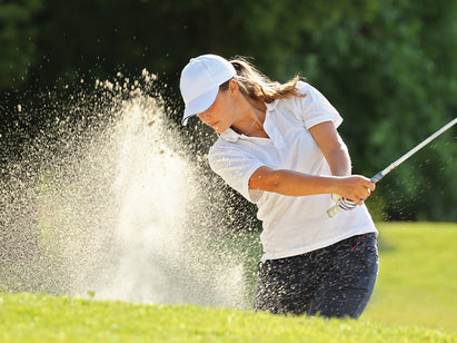 woman playing golf in the sun