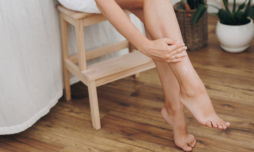 woman rubbing cream into her legs