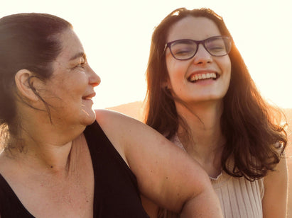 mother & daughter outside by sunset