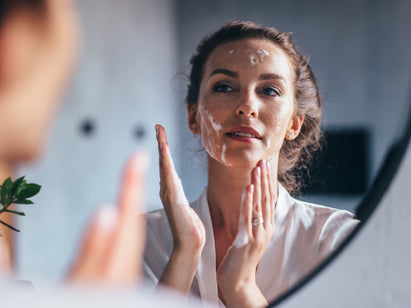 Woman putting face cream on