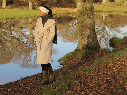 woman walking by a pond in autumn