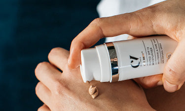 person applying natural make-up for sensitive skin to back of hand