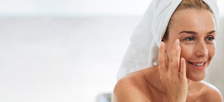 woman applying a microbiome skin care product