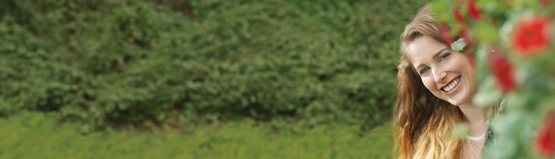 image for fluoride toothpaste category featuring woman smiling in garden