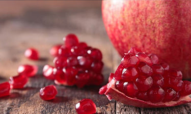 banner for natural lip balm for dry lips category featuring pomegranate seeds