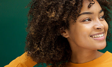 banner for natural shampoo for dry hair category featuring woman with her hand in her hair