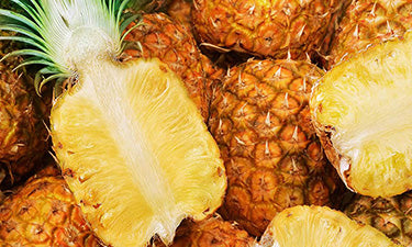 banner for natural face scrub category featuring pineapples